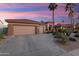 Exterior view of property with desert landscaping and a three-car garage at 16253 W Windcrest Dr, Surprise, AZ 85374