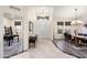 Bright foyer leads to living spaces, showcasing tile and wood flooring with neutral walls at 16253 W Windcrest Dr, Surprise, AZ 85374