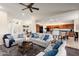 Spacious living room featuring neutral decor, a ceiling fan, and an open layout at 16253 W Windcrest Dr, Surprise, AZ 85374