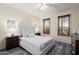 This cozy bedroom features wood-look floors, neutral walls, and a large picture window with an outdoor view at 16253 W Windcrest Dr, Surprise, AZ 85374