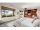 Serene main bedroom with backyard and water view, with built-in shelving and desk area at 16253 W Windcrest Dr, Surprise, AZ 85374