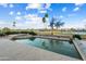 Sparkling pool and spa surrounded by lush landscaping, offering a private oasis for relaxation and recreation at 16253 W Windcrest Dr, Surprise, AZ 85374