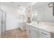 Bright bathroom features dual vanities, a glass shower, and modern fixtures at 17253 W Via Dona Rd, Surprise, AZ 85387