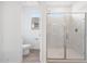 Clean bathroom featuring a tiled shower with a glass door and a separate toilet room at 17253 W Via Dona Rd, Surprise, AZ 85387