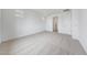 Neutral-toned bedroom with plush carpeting, two small windows, and white walls with white trim at 17253 W Via Dona Rd, Surprise, AZ 85387