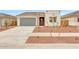 Charming single-story home with a modern design, desert landscaping, and a spacious two-car garage at 17253 W Via Dona Rd, Surprise, AZ 85387