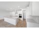 Bright, modern kitchen with white cabinets, stainless steel appliances, and a central island with bar seating at 17253 W Via Dona Rd, Surprise, AZ 85387