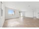 Bright and airy living room with tiled floors, large windows, and sliding glass doors to the backyard at 17253 W Via Dona Rd, Surprise, AZ 85387