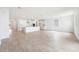 Open-concept living area featuring modern lighting, wood-look tile flooring, and a kitchen with island at 17253 W Via Dona Rd, Surprise, AZ 85387