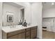 Bright bathroom featuring a double sink vanity with modern fixtures and a large mirror at 17742 W Brown St, Waddell, AZ 85355