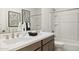 Bright bathroom featuring a double sink vanity with modern faucets, neutral walls, and a shower-tub combo at 17742 W Brown St, Waddell, AZ 85355