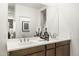 Bright bathroom featuring a double sink vanity with modern fixtures and a large mirror at 17742 W Brown St, Waddell, AZ 85355