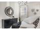 Staged bedroom featuring modern furniture, statement mirror, and modern art and accent lighting at 17742 W Brown St, Waddell, AZ 85355