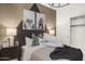 Staged bedroom featuring bold patterned walls, plush bedding, modern art and accent lighting at 17742 W Brown St, Waddell, AZ 85355