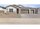 Beautiful single-Gathering home featuring a neutral color palette, desert landscaping, and a charming paver driveway at 17742 W Brown St, Waddell, AZ 85355