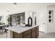 Modern kitchen with stainless steel appliances, an island with bar seating, and dark wood cabinets at 17742 W Brown St, Waddell, AZ 85355