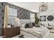 Serene main bedroom features a patterned accent wall, stylish lighting, and plush bedding at 17742 W Brown St, Waddell, AZ 85355