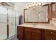 Bathroom featuring a glass shower and wooden vanity at 17810 W Club Vista Dr, Surprise, AZ 85374