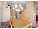 Dining area with wooden table and chair set under a chandelier at 17810 W Club Vista Dr, Surprise, AZ 85374