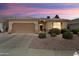 Charming home featuring a two-car garage, desert landscaping, and a beautiful tiled roof at 17810 W Club Vista Dr, Surprise, AZ 85374