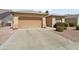 The house exterior shows a two car garage, driveway and mature landscaping at 17810 W Club Vista Dr, Surprise, AZ 85374