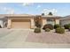 Charming single-story home with a well-manicured front yard and two-car garage, offering curb appeal at 17810 W Club Vista Dr, Surprise, AZ 85374