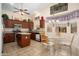 Spacious kitchen featuring wood cabinets, island and eat-in dining area with a vaulted ceiling at 17810 W Club Vista Dr, Surprise, AZ 85374