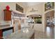 Open kitchen layout featuring an island, dining area, and views into the living room at 17810 W Club Vista Dr, Surprise, AZ 85374