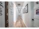 Long hallway with wood floors and neutral walls, enhanced by decorative wall art and trim at 18125 W Montebello Ct # 67, Litchfield Park, AZ 85340