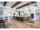Open kitchen with stainless steel appliances, a large island with seating, and hardwood floors at 18125 W Montebello Ct # 67, Litchfield Park, AZ 85340