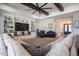 Spacious living room with an oversized sectional, wood beams, built-in shelves and entertainment center at 18125 W Montebello Ct # 67, Litchfield Park, AZ 85340