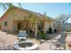 Inviting backyard featuring a cozy fire pit and beautiful landscaping to create a relaxing outdoor space at 1815 S San Marcos Dr, Apache Junction, AZ 85120