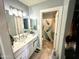 Well-lit bathroom with vanity, double mirrors, and a separate shower at 1815 S San Marcos Dr, Apache Junction, AZ 85120