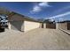 Charming exterior view of home featuring a garage, long driveway, and side gravel parking area at 1815 S San Marcos Dr, Apache Junction, AZ 85120