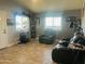 Comfortable living room featuring wood-look flooring and a reclining sofa set at 1815 S San Marcos Dr, Apache Junction, AZ 85120