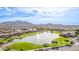 Panoramic aerial view of the community, showcasing homes, a pond, and mountain backdrop at 2196 E Brigadier Dr, Gilbert, AZ 85298