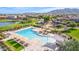 Aerial shot of the community pool, playground, and surrounding neighborhood with a lake at 2196 E Brigadier Dr, Gilbert, AZ 85298