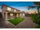 Spacious backyard featuring low-maintenance landscaping with artificial turf and decorative rock at 2196 E Brigadier Dr, Gilbert, AZ 85298