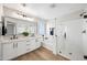 Luxurious bathroom featuring double vanities, black matte fixtures, a soaking tub, and a glass-enclosed shower at 2196 E Brigadier Dr, Gilbert, AZ 85298