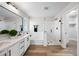 Modern bathroom featuring double sinks, matte black hardware, an enclosed shower, and a soaking tub with a window at 2196 E Brigadier Dr, Gilbert, AZ 85298