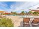 Resort-style community pool area with lounge chairs, umbrellas, and a play area at 2196 E Brigadier Dr, Gilbert, AZ 85298