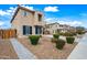 Charming two-story home featuring neutral stucco and a tile roof, complemented by a quaint landscaped front yard at 2196 E Brigadier Dr, Gilbert, AZ 85298