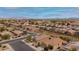 This aerial view shows a well-planned neighborhood with mature trees, landscaped yards, and convenient street layouts at 25067 W Dove Trl, Buckeye, AZ 85326