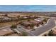 An aerial view of a subdivision shows well-maintained homes, landscaping, nearby commercial development and mountain views at 25067 W Dove Trl, Buckeye, AZ 85326