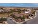 Aerial view of a residential neighborhood showcasing well-maintained homes, green spaces, and scenic mountain views at 25067 W Dove Trl, Buckeye, AZ 85326