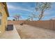 Backyard with brick patio, gravel, and perimeter wall offering privacy, ideal for landscaping and relaxing outdoors at 25067 W Dove Trl, Buckeye, AZ 85326