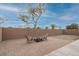 Large backyard with brick-paved patio, seating area, fire pit and high block wall for added privacy at 25067 W Dove Trl, Buckeye, AZ 85326