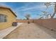 This backyard has a gravel ground covering with a patio area surrounded by a brick fence for maximum privacy at 25067 W Dove Trl, Buckeye, AZ 85326