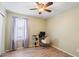 Neutral-toned bedroom with a ceiling fan, desk, and chair, perfect for a home office or study area at 25067 W Dove Trl, Buckeye, AZ 85326