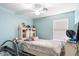 Cozy bedroom featuring light blue walls, a ceiling fan, and a built-in headboard with storage at 25067 W Dove Trl, Buckeye, AZ 85326